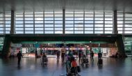 AirAsia passengers wearing face masks walk to the check-in counter at the Kuala Lumpur International Airport 2 in Sepang on April 29, 2020. / AFP / Mohd RASFAN