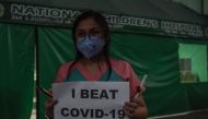 A medical staff member from the National Children's Hospital take part in a vigil to honour their fallen colleagues and call on the government to provide ample protection to frontline staff and the immediate release of their bonuses, in Quezon City on Apr