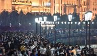 :TOPSHOT - Large crowd of people wearing face masks visit the promenade on the Bund along the Huangpu River during a holiday on May Day, or International Workers' Day, in Shanghai on May 1, 2020. With optimism and a heavy dose of caution, millions of Chin