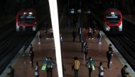 Commuters wearing protective masks keep social distancing as they wait for their train at the Atocha train station, on the first day mask usage is mandatory in public transport, amid the coronavirus disease (COVID-19) outbreak in Madrid, Spain, May 4, 202