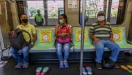 TOPSHOT - People wear face masks and sit on designated seats on a metro car as a preventive measure against the spread of the novel coronavirus COVID-19, in Medellin, Colombia, on May 4, 2020./ AFP / Joaquin SARMIENTO