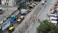 Police officers march on a street in Dharavi, one of Asia's largest slums, after the extension of the lockdown in Maharashtra state, to control the spread of coronavirus disease (COVID-19), in Mumbai, India, April 11, 2020. REUTERS/Francis Mascarenhas/Fil