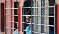 A migrant worker, who was stranded in the western state of Gujarat due to a lockdown imposed by the government to prevent the spread of the coronavirus disease (COVID-19), looks out from a window of a train that will take him to his home state of Uttar Pr