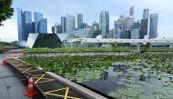 Tape is used to mark off spaces for social distancing at a seating area, as a preventive measure against the spread of the COVID-19 novel coronavirus, along the promenade at Marina Bay in Singapore on May 4, 2020. / AFP / Roslan RAHMAN