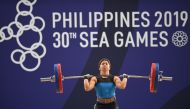 (FILES) This file photo taken on December 2, 2019 shows Hidilyn Diaz of the Philippines competing in the women's 55kg weightlifting clean and jerk event at the SEA Games (Southeast Asian Games) in Manila. AFP / Ted ALJIBE