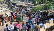 Rohingya refugees gather at a market as first cases of COVID-19 coronavirus have emerged in the area, in Kutupalong refugee camp in Ukhia on May 15, 2020.   AFP / Suzauddin RUBEL
