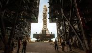 FILE PHOTO: NASA employees look on as the Artemis launch tower rolls back from Pad 39B inside Bay 3 of the Vehicle Assembly Building (VAB) at the Kennedy Space Center in preparation for the landfall of Hurricane Dorian, in Cape Canaveral, Florida, U.S., A