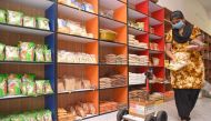 A store worker fills the tray of the robot with food items in Coimbatore, on May 13, 2020. AFP / STR