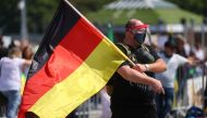 A man wearing a face mask attends a protest against the government's restrictions following the coronavirus disease (COVID-19) outbreak, at Cannstatter Wasen area in Stuttgart, Germany, May 16, 2020. REUTERS/Kai Pfaffenbach