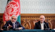 In this handout photograph taken on May 17, 2020 and released by Afghanistan's Office of Chief Executive, politician Abdullah Abdullah (L) gestures as he speaks next to Afghan President Ashraf Ghani (R) ahead of signing a power-sharing deal agreement at t