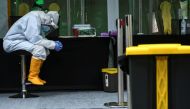 A medical staff member waits to take a swab sample from a citizen amid the coronavirus disease (COVID-19) outbreak, in Jakarta, Indonesia May 20, 2020. Antara Foto/Muhammad Adimaja 
