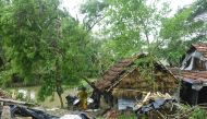 A woman salvages items from her house damaged by cyclone Amphan in Midnapore, West Bengal, on May 21, 2020.  / AFP / Dibyangshu SARKAR
