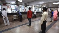 People queue at a railway reservation counter after the government eased restrictions imposed as a preventive measure against the spread of the COVID-19 Coronavirus in New Delhi on May 22, 2020. / AFP / Money Sharma 