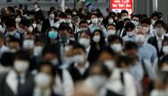 People wearing protective masks make their way during rush hour at Shinagawa station on the first day after the Japanese government lifted the state of emergency in Tokyo, Japan, May 26, 2020.REUTERS/Kim Kyung-Hoon
