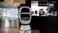 A robot that takes orders, makes coffee and brings the drinks straight to customers at their seats is seen at a cafe in Daejeon, South Korea, May 25, 2020. REUTERS/Kim Hong-Ji
