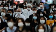 People wearing protective masks make their way during rush hour at Shinagawa station on the first day after the Japanese government lifted the state of emergency in Tokyo, Japan, May 26, 2020.REUTERS/Kim Kyung-Hoon