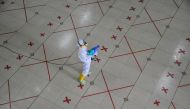 A worker sprays disinfectant after Friday prayers at a mosque to prevent the spread of coronavirus disease (COVID-19) outbreak in Bekasi, near Jakarta, Indonesia May 29, 2020, in this photo taken by Antara Foto. Antara Foto/Fakhri Hermansyah