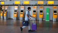 A passenger rushes past check-in desks prior to the first Lufthansa charter flight for Tianjin, China after the lockdown, as the spread of the coronavirus disease (COVID-19) continues, at the airport in Frankfurt, Germany, May 29, 2020. REUTERS/Kai Pfaffe