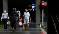 People wearing face masks cross a street amid the coronavirus disease (COVID-19) outbreak in Singapore on June 1, 2020. REUTERS/Edgar Su