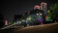 People wearing face masks walk along Hankou Park in Wuhan, in China's central Hubei province on May 28, 2020.  / AFP / Hector RETAMAL