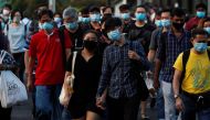 People cross a street during morning peak hour commute amid the coronavirus disease (COVID-19) outbreak in Singapore June 3, 2020. REUTERS/Edgar Su
