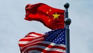FILE PHOTO: Chinese and U.S. flags flutter near The Bund in Shanghai, China July 30, 2019. REUTERS/Aly Song/File Photo
