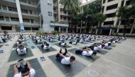 Members of the Bangladesh police attend a yoga session to boost the immune system of police personnel during the COVID-19 coronavirus pandemic, in Dhaka on July 8, 2020. / AFP / Munir UZ ZAMAN