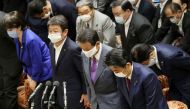 Japan's Prime Minister Shinzo Abe (R) and Finance Minister Taro Aso (2nd R) wearing face masks amid concerns over the spread of coronavirus (COVID-19) bow during a budget committee session in the lower house at parliament in Tokyo on June 10, 2020. AFP / 