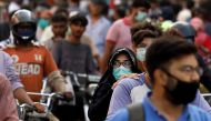 FILE PHOTO: A woman rides on a motor bike as she wears a protective face mask amid the rush of people outside a market as the outbreak of the coronavirus disease (COVID-19) continues, in Karachi, Pakistan June 8, 2020. REUTERS/Akhtar Soomro/File Photo
