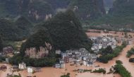 TOPSHOT - This photo taken on June 7, 2020 shows submerged streets and inundated buildings after heavy rain caused flooding in Yangshuo, in China's southern Guangxi region. / AFP / STR
