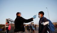 A learner is screened as schools begin to reopen after the coronavirus disease (COVID-19) lockdown in Langa township in Cape Town, South Africa June 8, 2020. REUTERS/Mike Hutchings/File Photo
 