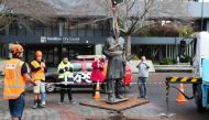 Workers remove a controversial statue of Captain John Fane Charles Hamilton from Civic Square in Hamilton on June 12, 2020, / AFP / MICHAEL BRADLEY