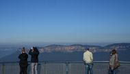 Tourists take in the view at a Three Sisters rock formation lookout in Blue Mountains National Park in the wake of regional travel re-opening as the coronavirus disease (COVID-19) restrictions are eased in New South Wales, in Katoomba, Australia, June 5, 