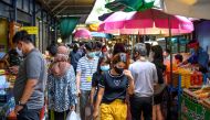 People walk in a street food market in Bangkok on June 9, 2020. / AFP / Mladen ANTONOV