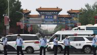 TOPSHOT - Chinese police guard the entrance to the closed Xinfadi market in Beijing on June 13, 2020. Eleven residential estates in south Beijing have been locked down due to a fresh cluster of coronavirus cases linked to the Xinfadi meat market, official