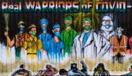 A man walks past a mural painted on a garbage dump after the government eased a nationwide lockdown imposed as a preventive measure against the COVID-19 coronavirus in New Delhi on June 13, 2020. AFP / Jewel Samad 