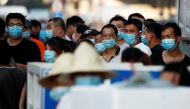 People are wearing face masks inside the Jingshen seafood market which has been closed for business after new coronavirus infections were detected, in Beijing, China, June 12, 2020. REUTERS/Thomas Peter