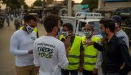 Members of Prime Minister Imran Khan's Corona Relief Tiger Force volunteers gather before starting a COVID-19 coronavirus awareness campaign at Raja bazar in Rawalpindi on June 10, 2020.  / AFP / Farooq NAEEM

