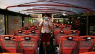 A tour guide adjust her face mask to protect herself from the coronavirus disease (COVID-19) in an empty Taipei Sightseeing bus in Taipei, Taiwan, May 22, 2020. REUTERS/Ann Wang/File Photo