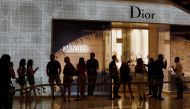 People form a line outside a Dior store in Singapore as the city state reopens the economy amid the coronavirus disease (COVID-19) outbreak, June 19, 2020. Reuters/Edgar Su