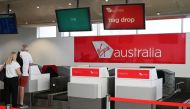 Travelers stand at a Virgin Australia Airlines counter at Kingsford Smith International Airport, following the coronavirus outbreak, in Sydney, Australia, March 18, 2020. REUTERS/Loren Elliott/File Photo