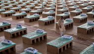 A volunteer walks past disposable beds made out of cardboard at the campus of Radha Soami Satsang Beas, a spiritual organization, where a coronavirus disease (COVID-19) care centre has been constructed for the patients amidst the spread of the disease, in