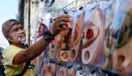 A vendor sells face design masks at a traditional market to prevent the spread of the coronavirus disease (COVID-19) outbreak, in Jakarta, Indonesia June 23, 2020. Picture taken June 23, 2020 REUTERS/Ajeng Dinar Ulfiana
