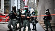 In this file photo riot police officers stand guard ahead of a pro-democracy march in the Central district of Hong Kong on June 9, 2020. AFP / Anthony Wallace 