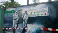 A wall mural depicts an advocacy message on fumigation as a measure against coronavirus disease (COVID-19) outbreak, on the walls of the Kinshasa Academy of Fine Arts in Kinshasa, Democratic Republic of Congo June 22, 2020. Picture June 22, 2020. REUTERS/