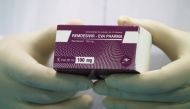 FILE PHOTO: A lab technicians holds the coronavirus disease (COVID-19) treatment drug 