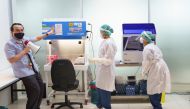 A doctor and medical staffs wearing personnel protective equipment (PPE) demonstrate the lab workflow at the COVID-19 testing laboratory at Bangkok's Suvarnabhumi International airport amid the spread of the coronavirus disease (COVID-19), Thailand, June 
