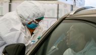 A healthcare worker gives a Covid-19 test to a medical staff near Halyk Arena in Almaty, on July 5, 2020 as Kazakhstan imposed a second round of nationwide restrictions to counter a huge surge in coronavirus cases since the previous lockdown that has over