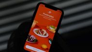 This file illustration photo taken on June 30, 2020 shows the logo of delivery app Postmates on a smartphone screen in Los Angeles. / AFP / Chris DELMAS
