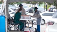 Medical personnel work at a COVID-19 testing center on July 7, 2020 in Austin, Texas. Sergio Flores/Getty Images/AFP